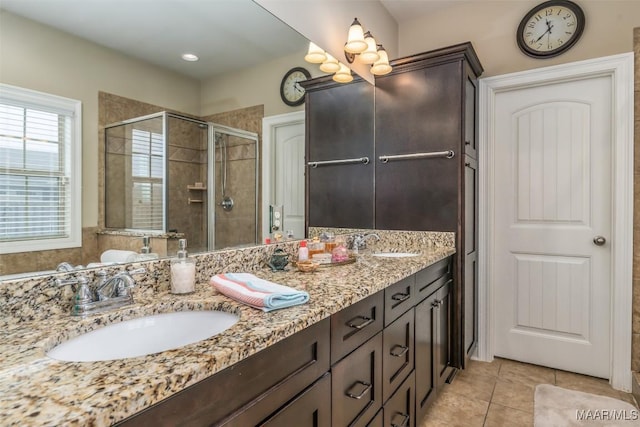 bathroom featuring vanity, an enclosed shower, and tile patterned floors