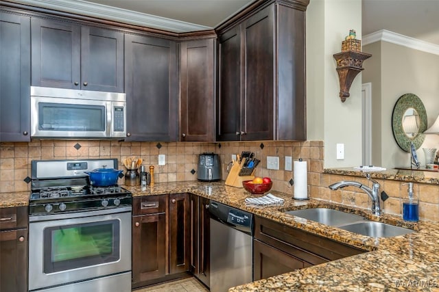 kitchen with stone countertops, sink, decorative backsplash, stainless steel appliances, and crown molding