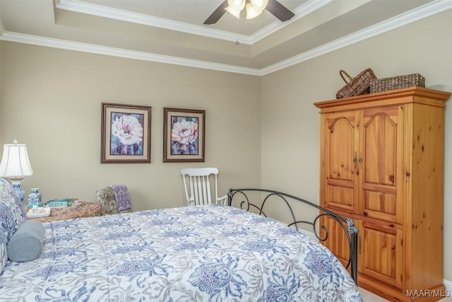 bedroom featuring a raised ceiling, crown molding, and ceiling fan