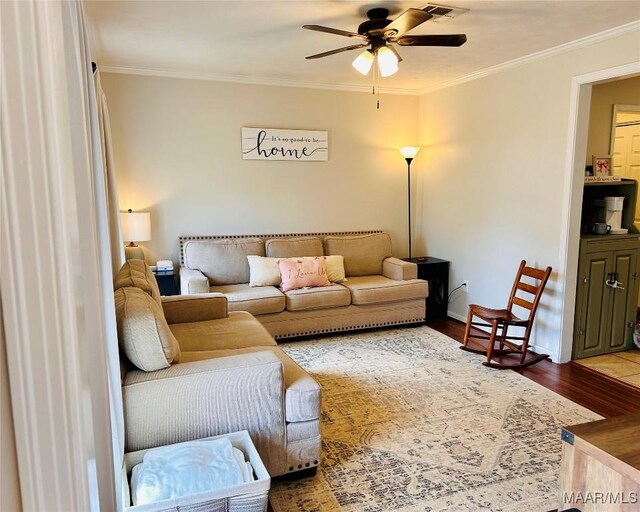 living room with ornamental molding, hardwood / wood-style floors, and ceiling fan