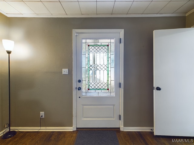 entrance foyer with ornamental molding and dark wood-type flooring