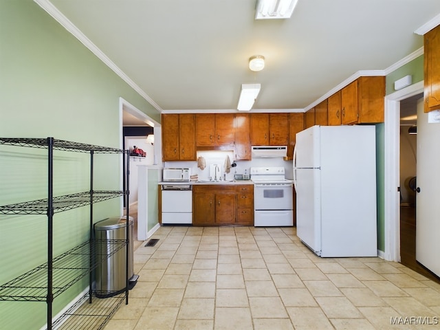 kitchen with crown molding, sink, and white appliances