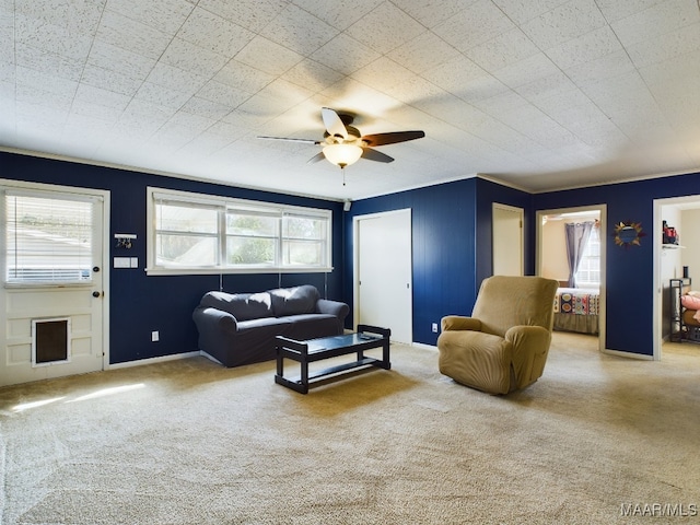 living room with ceiling fan and carpet