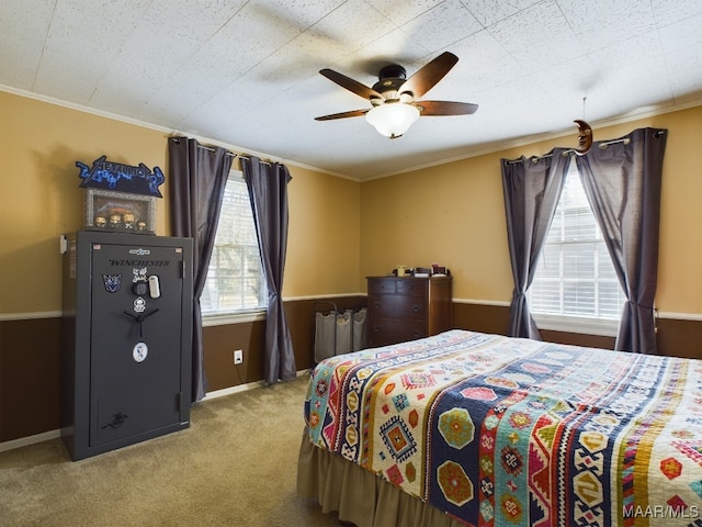 bedroom with ornamental molding, light colored carpet, and ceiling fan