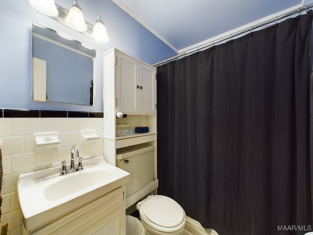 bathroom with tile walls, vanity, ornamental molding, toilet, and walk in shower