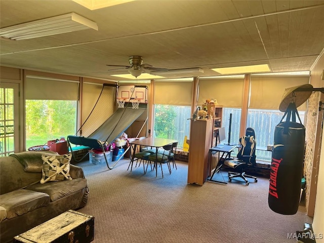 game room with ceiling fan and carpet