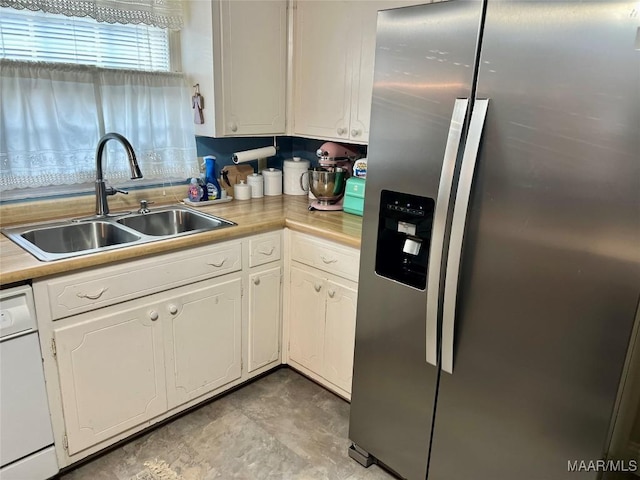 kitchen with dishwasher, white cabinetry, sink, and stainless steel fridge with ice dispenser