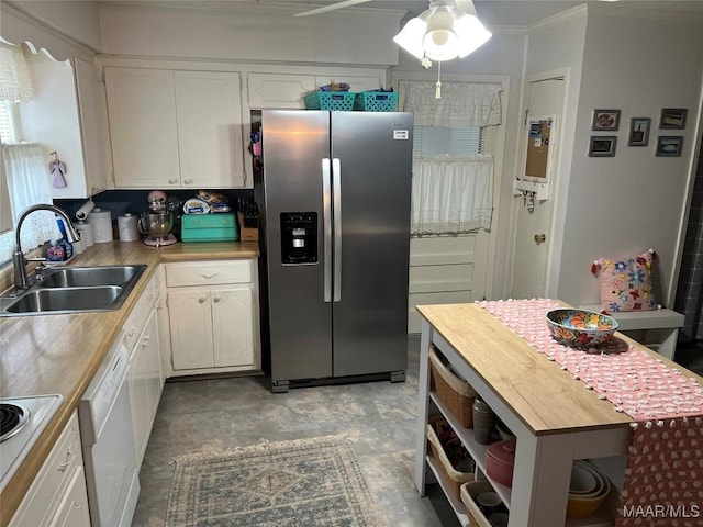 kitchen with wood counters, sink, crown molding, white appliances, and white cabinets