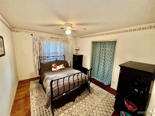 bedroom with hardwood / wood-style flooring and ceiling fan