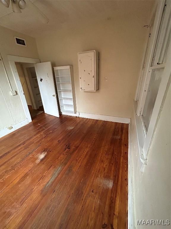 unfurnished bedroom with hardwood / wood-style floors and ceiling fan