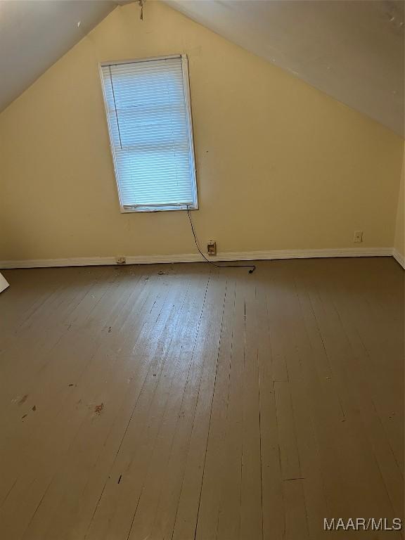 additional living space featuring hardwood / wood-style flooring and lofted ceiling