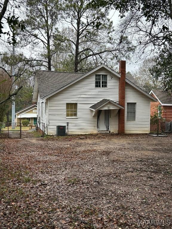 rear view of house featuring central AC unit