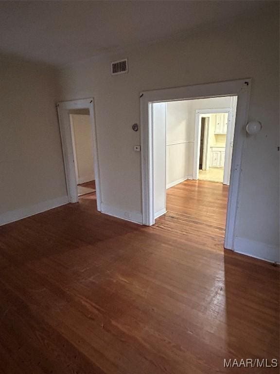 empty room with hardwood / wood-style floors