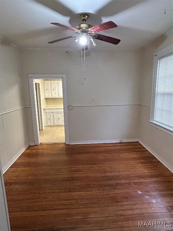 unfurnished room with ceiling fan and dark hardwood / wood-style flooring