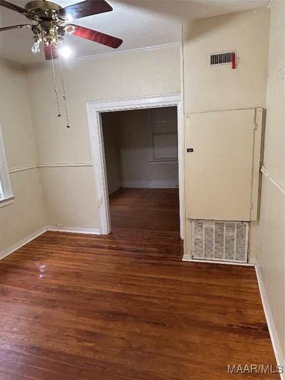 empty room featuring ceiling fan and dark hardwood / wood-style flooring