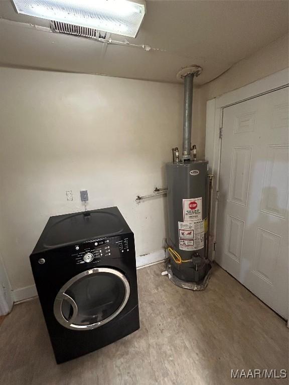 washroom featuring gas water heater and washer / dryer