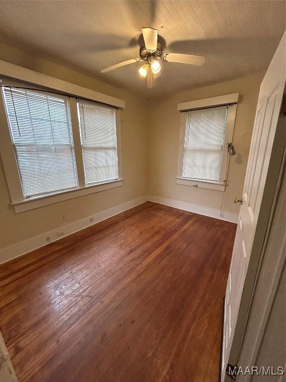 interior space featuring dark wood-type flooring and ceiling fan