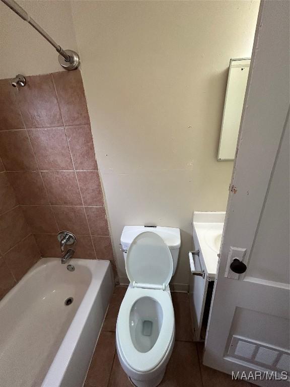 full bathroom with tile patterned floors, vanity, toilet, and tiled shower / bath combo