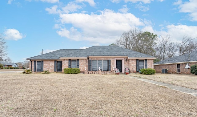 single story home with central AC unit and a front lawn