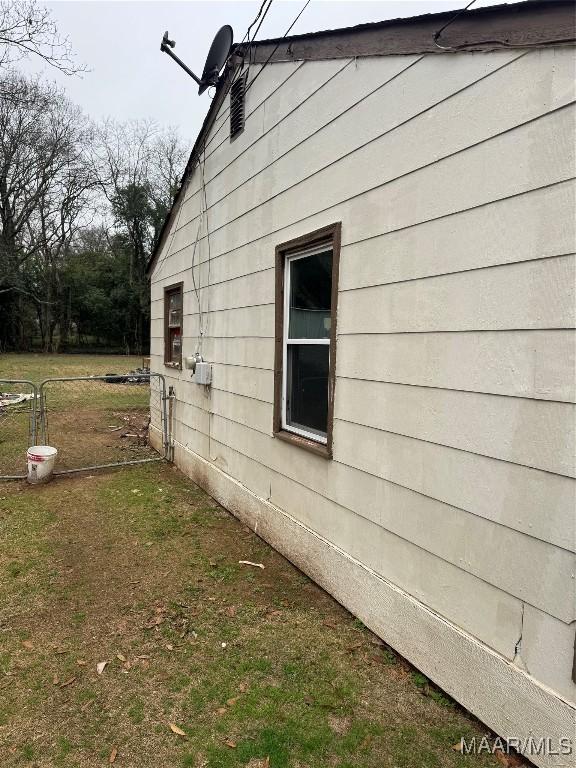 view of home's exterior with a yard