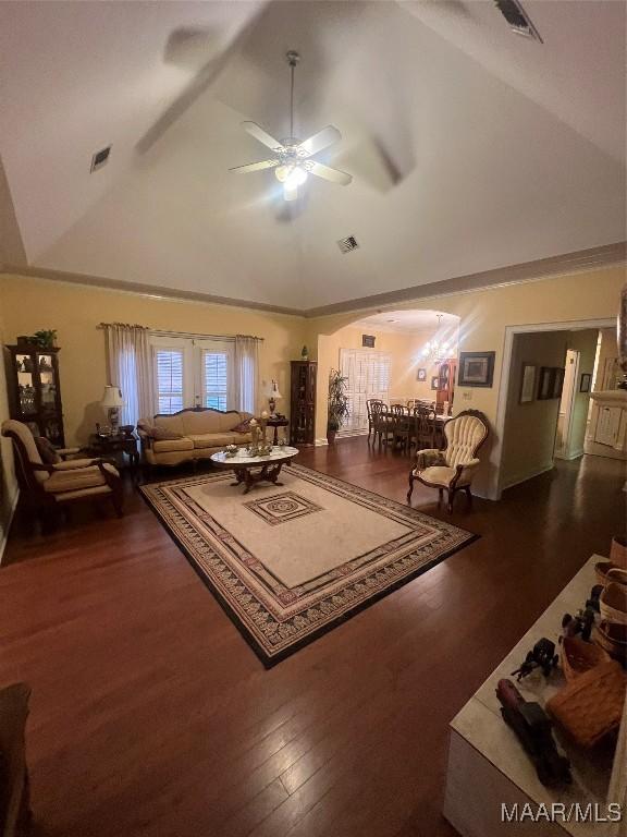 living room featuring dark wood-type flooring, ceiling fan, and high vaulted ceiling