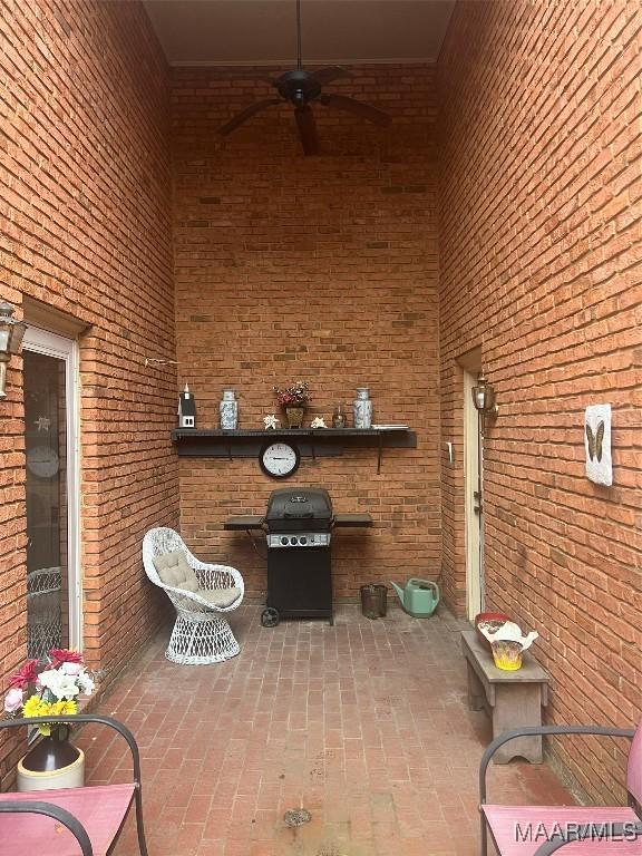 view of patio with ceiling fan and grilling area