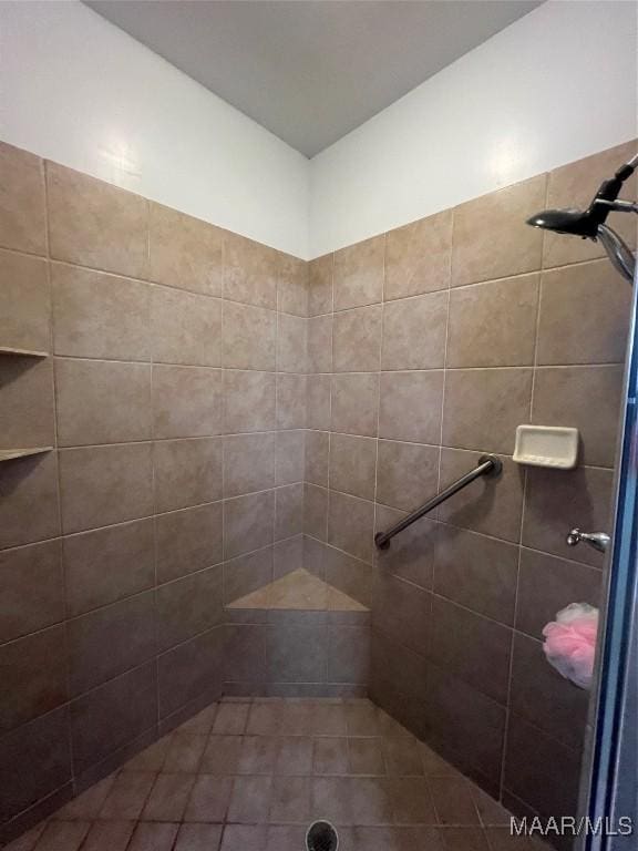 bathroom with tiled shower