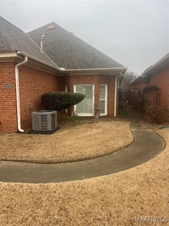 view of home's exterior featuring a yard and cooling unit