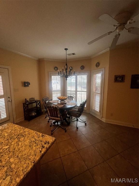 tiled dining room featuring lofted ceiling, ceiling fan with notable chandelier, and ornamental molding