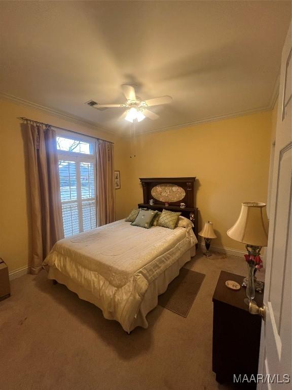 bedroom with crown molding, carpet flooring, and ceiling fan