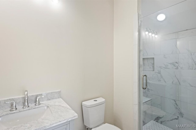 bathroom with vanity, an enclosed shower, and toilet