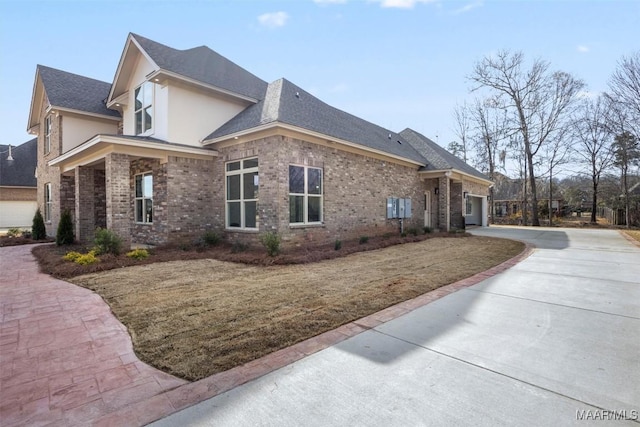 view of side of property with a yard and a garage