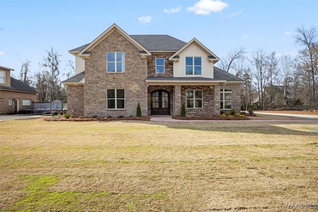 craftsman house featuring a front lawn and french doors