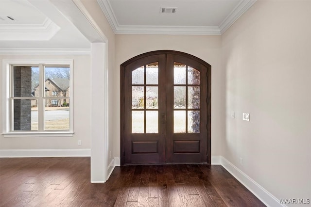 foyer featuring french doors, ornamental molding, and dark wood-type flooring