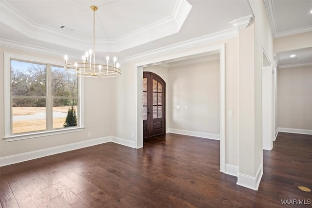 unfurnished dining area featuring a raised ceiling, ornamental molding, an inviting chandelier, and dark hardwood / wood-style flooring