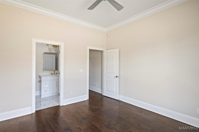 unfurnished bedroom featuring crown molding, dark wood-type flooring, ensuite bath, and ceiling fan