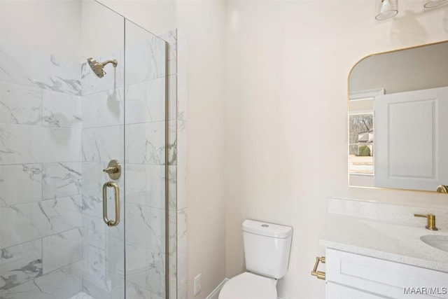 bathroom featuring vanity, toilet, and walk in shower