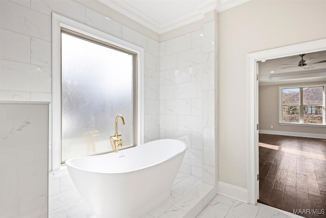 bathroom featuring ornamental molding, a tub, and ceiling fan