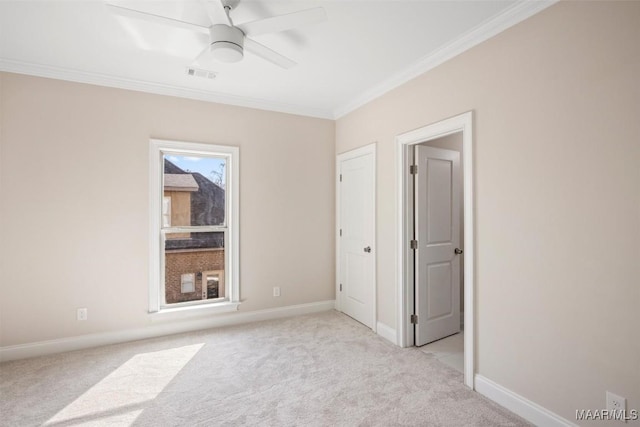 unfurnished bedroom with ceiling fan, light colored carpet, and ornamental molding