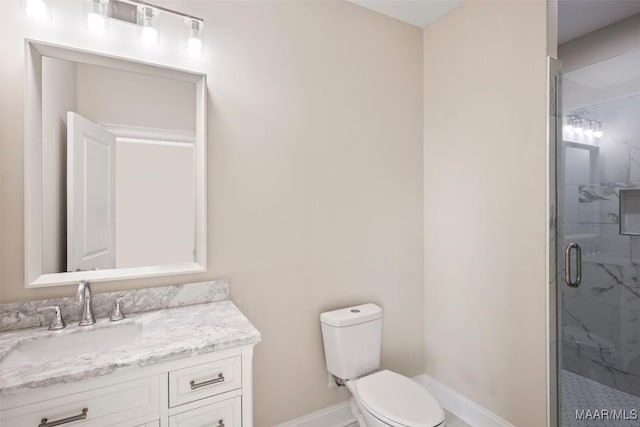 bathroom with vanity, an enclosed shower, and toilet