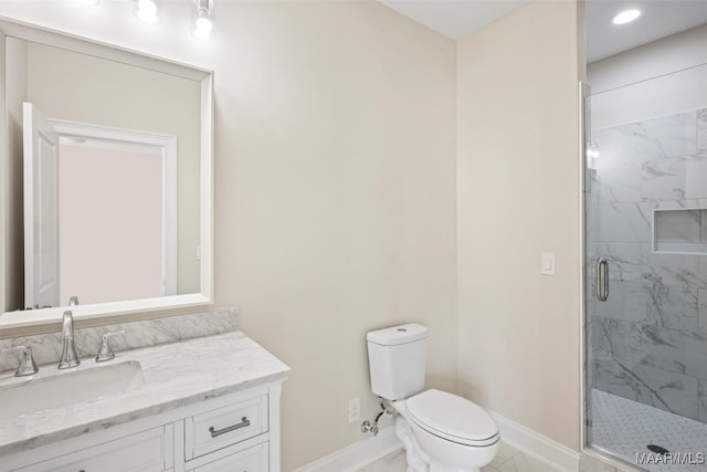 bathroom featuring vanity, toilet, and an enclosed shower