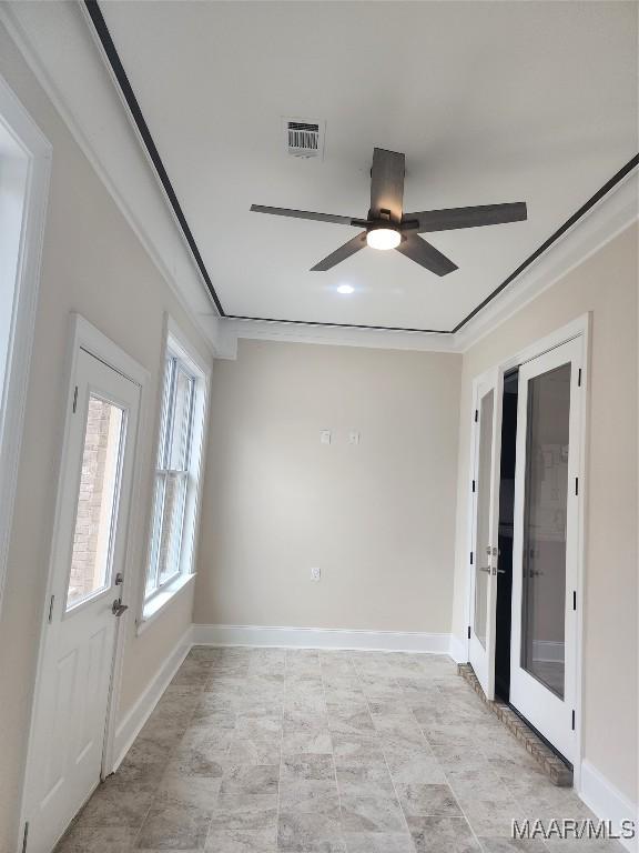 spare room featuring crown molding and ceiling fan