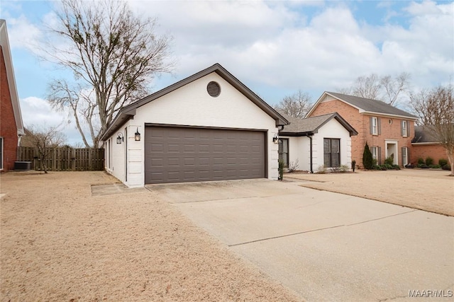 view of front of home featuring central AC unit and a garage