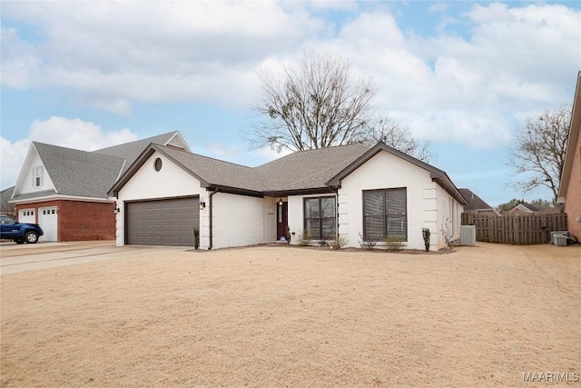 view of front of home featuring cooling unit and a garage