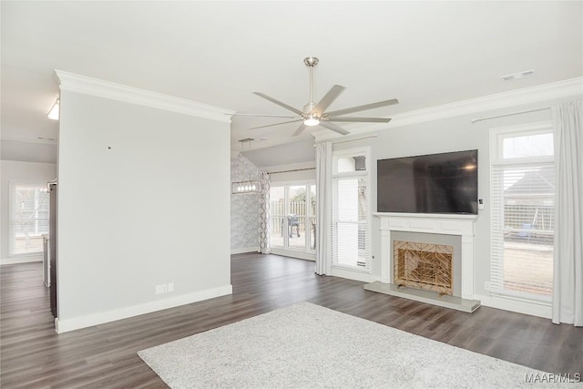 unfurnished living room featuring dark hardwood / wood-style flooring, ornamental molding, and ceiling fan