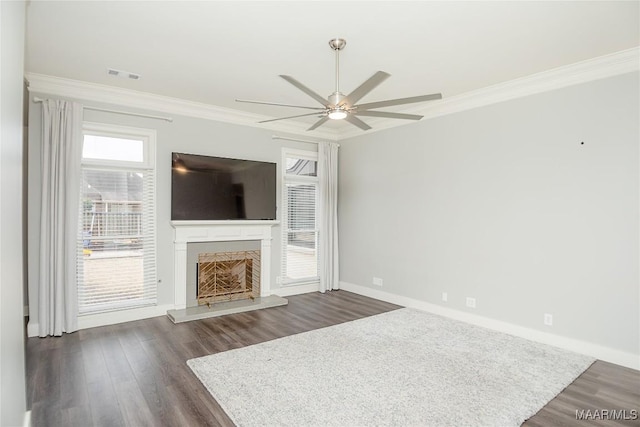 unfurnished living room featuring dark wood-type flooring, ornamental molding, and ceiling fan