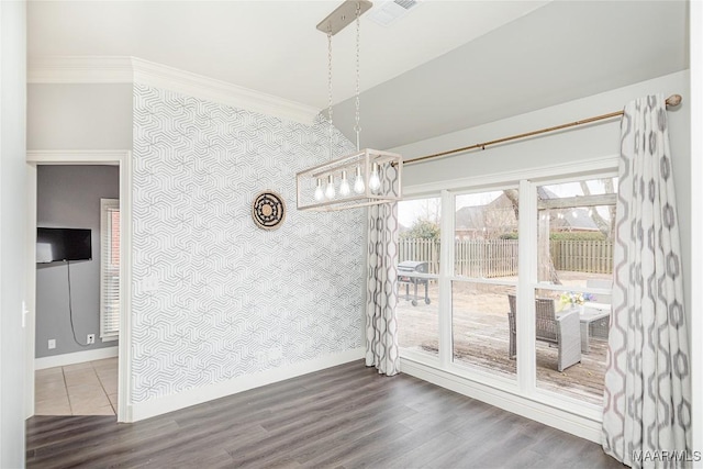 unfurnished dining area with ornamental molding and hardwood / wood-style floors