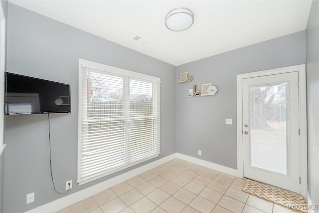 entryway with light tile patterned floors