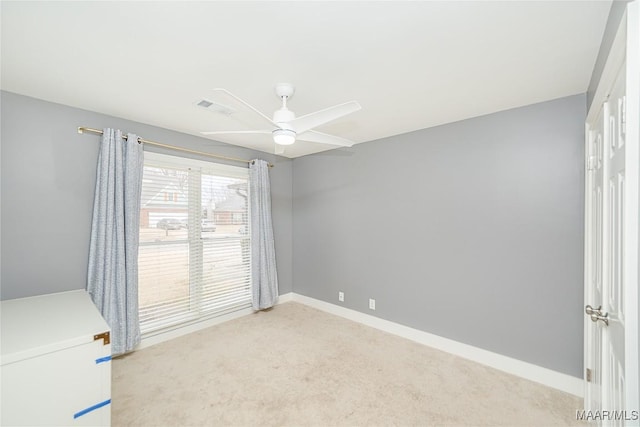 spare room featuring ceiling fan and light colored carpet