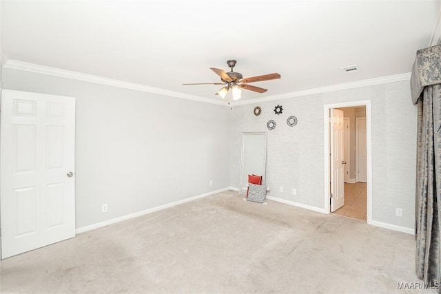 unfurnished bedroom with ceiling fan, ornamental molding, and light carpet